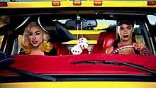 Gaga, sarı renkli kamyonette şoför olan Beyoncé'nin yanında oturuyor. Büyük bir şapka takıyor ve dikiz aynasından zarlar sallanıyor.
